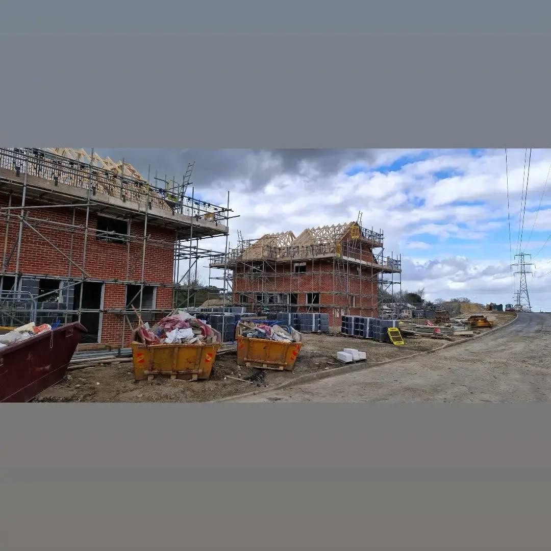 Panoramic view of houses under construction with roof trusses