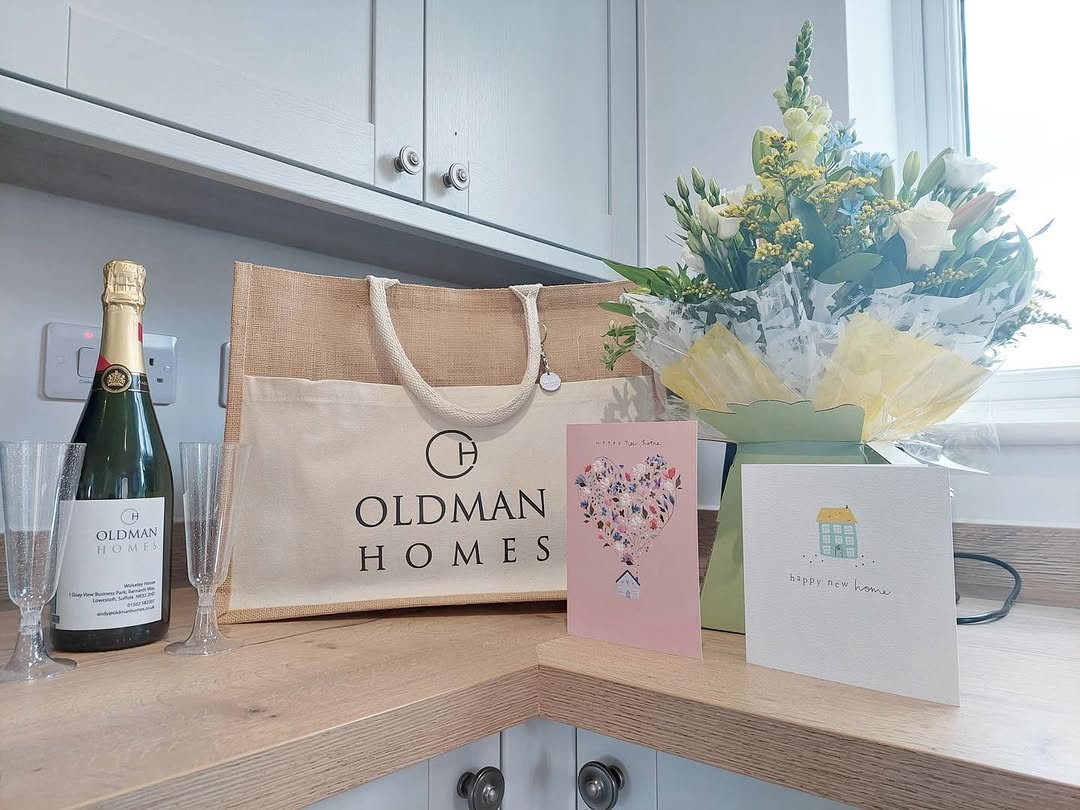Welcome pack — champagne, flowers, and Happy New Home cards