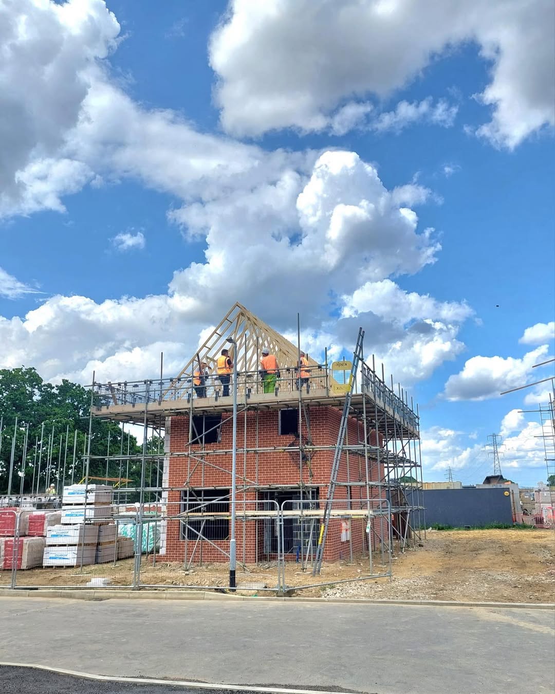 Roof truss installation — workers on scaffolding