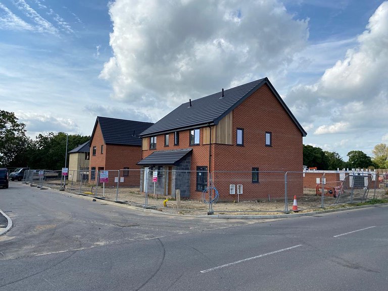 Houses nearing completion — brickwork and roofing done