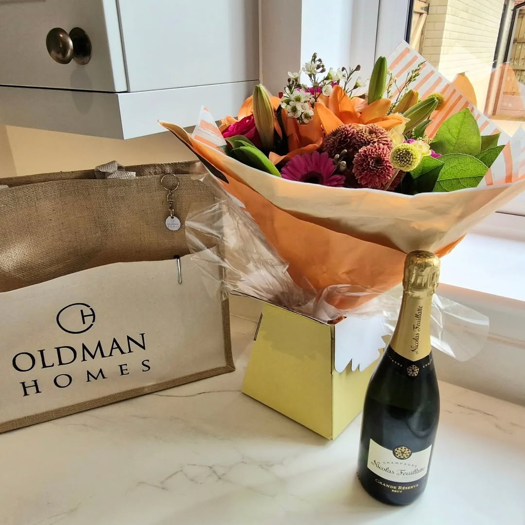 New home handover — champagne, flowers and Oldman Homes gift bag